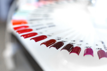 Table full of manicure utensils, manicure tools, nail polish colours on palette. Nails art accessories.の写真素材
