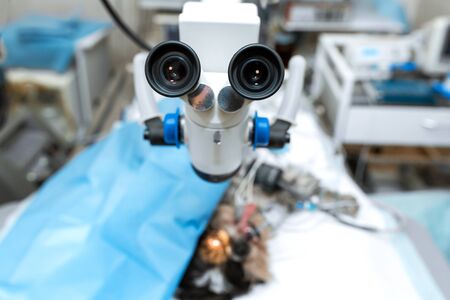 Vet ophthalmologist surgical microscope in operating room. and dog with injured eye on operating table, ready for operation.の写真素材