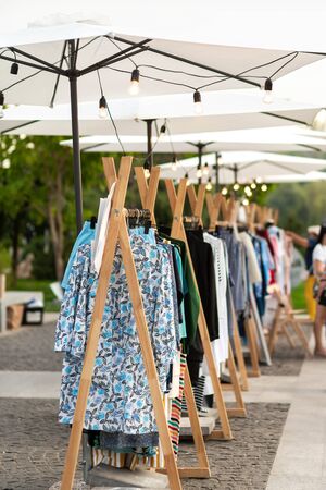 Racks with clothes outdoors. Designer sells clothes at a city fair.の写真素材
