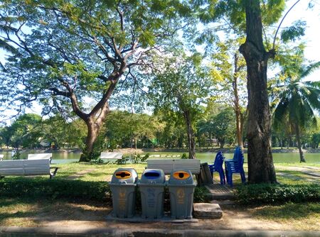 Three baskets for different garbage in a lumpini park in bangkok. Garbage sorting and environmental...