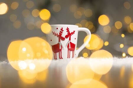 Christmas-themed mug with deer. Cozy warm family atmosphere, festive decor.の写真素材