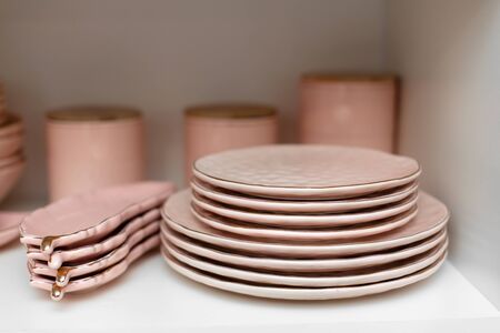 A set of pink dishes on a shelf in a store.の写真素材