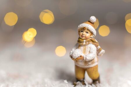 figurine boy holding snowballs in his hands.の写真素材