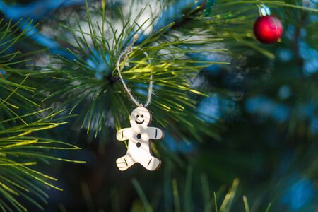 Festive decorations of a Christmas tree on the street. Close-up of branches with decorative toys.