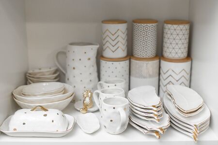 Dishes shop. Shelf in the cupboard with a set of dishes.の写真素材