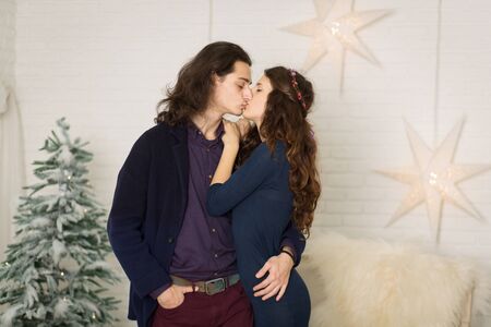 young couple posing in christmas decorations in retro style.の写真素材