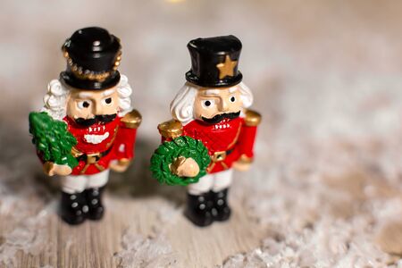 Decorative Christmas-themed figurines. Christmas toy soldiers from a nutcracker fairy tale. Christmas tree decoration. Festive decor, warm bokeh lightsの写真素材