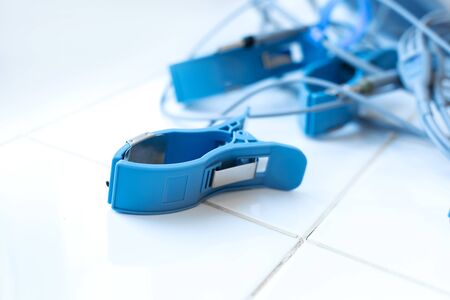 electrode clothespin for ECG diagnostics, lies on a white tile in the medical room.の写真素材
