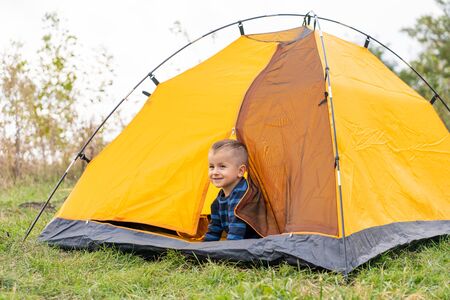 Little boy in a tent. Camping in the natureの写真素材