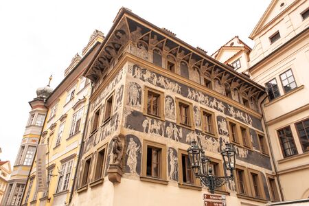 The architecture of the old city of Prague. The ancient building is painted with figures of peopleの写真素材
