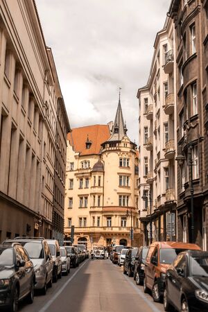 The architecture of the old city of Prague. Long empty street with paving stones on the ground and ancient buildings.のeditorial素材