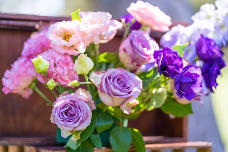 Bouquets of fresh flowers decoration of the festive table. Celebrating an open air party. Decor Details.の写真素材