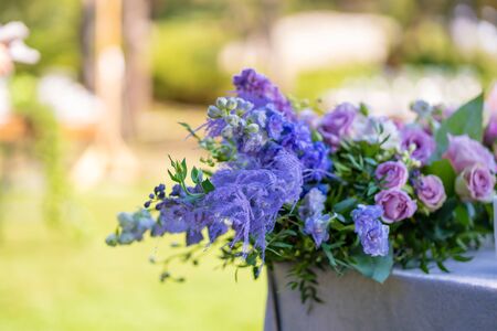 Bouquets of fresh flowers decoration of the festive table. Celebrating an open air party. Decor Details.の写真素材