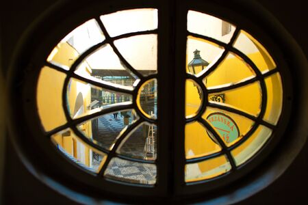 The architecture of the old city of Prague. Unusually round staircase window in the entrance hall.の写真素材