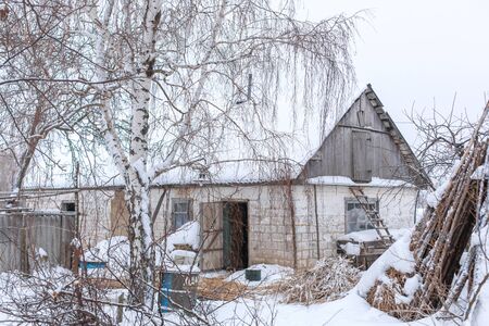 Winter countryside landscape, dilapidated abandoned ruined building covered in snowの写真素材