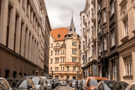 The architecture of the old city of Prague. A retro car rides in the middle of the old city streetのeditorial素材