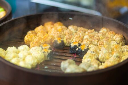 Colorful steamed dim sum, chinese dumpling in a wooden steamer. at Jalan Alor night market, Kuala Lumpur, Malaysia.の写真素材