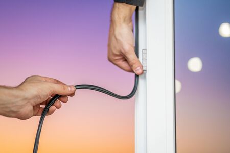 Professional master at repair and installation of windows, changes rubber seal gasket in pvc windows.の写真素材