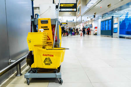 A set of tools and plates for mopping at the airport. Yellow bucket plates and brushes. Cleaning Service.のeditorial素材