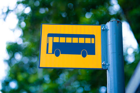 Bus stop sign on a metal pole.の写真素材