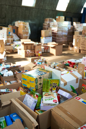 Food an hygiene humanitarian aid for Ukraine sorted in parcels before sent out to temponary moved persons. Dnipro, Ukraine - 07.06.2022のeditorial素材