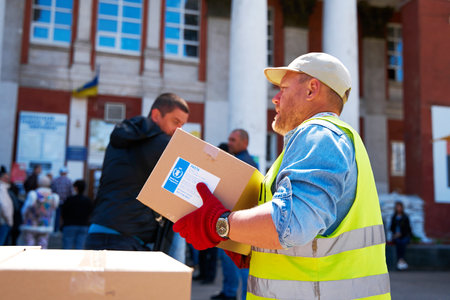 Ukrainian volunteers unloading boxes with humanitarian aid. Dnipro, Ukraine - 05.17.2022