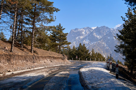Dangerous winding road among the mountains. Mountain streamer in early spring. Spectacular mountain landscape.の写真素材