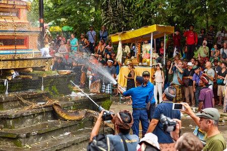 Cremation ceremony for a member of the Korolev family on the island of Bali. Workers extinguishing the altar after cremation. Bali, Indonesia - 03.02.2018のeditorial素材
