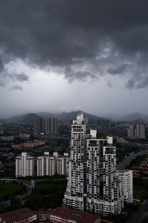A black storm cloud of rain over the town. bad weather conditions. Kuala Lumpur, Malaysia - 11.11.2022のeditorial素材