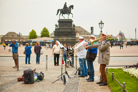 A group of street musicians play trumpets in the town square. Dresden, Germany - 05.20.2019のeditorial素材