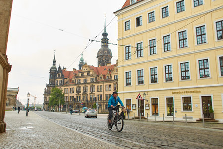 A resident of a European city goes about his business on a bicycle. Dresden, Germany - 05.20.2019のeditorial素材