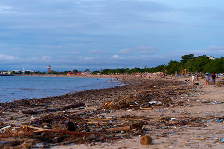 Mountains of waste and garbage on the sandy beach after the tide. Humanity is polluting the ocean.の写真素材