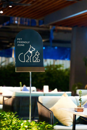 a pet-friendly cafe sign on a sunny summer terrace, inviting pet owners to relax and enjoy a meal with their furry friends. The warm, inviting atmosphere and picturesque surroundingsの写真素材