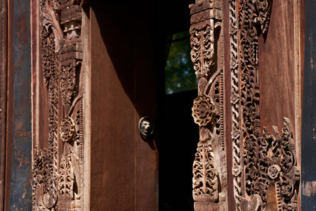 Artistic Woodcarving: Intricate Door Panel Design in a Thai Temple.の写真素材