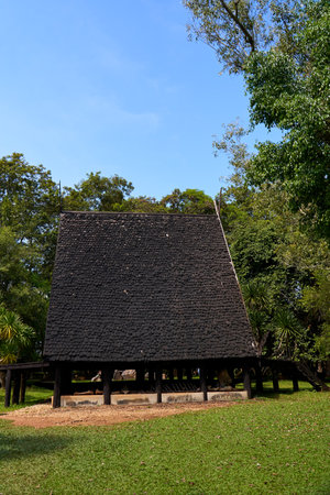 This photo features a pavilion with a striking black roof located on the grounds of the Black Temple in Thailand. The pavilion's design is intricate and ornate, with traditional Thai elements incorporated into the structure.の写真素材