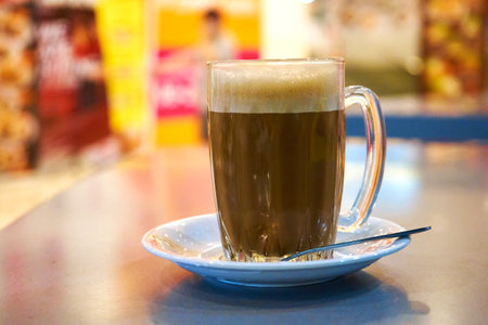 Glass cup with cocoa on a table in a cafe.の写真素材