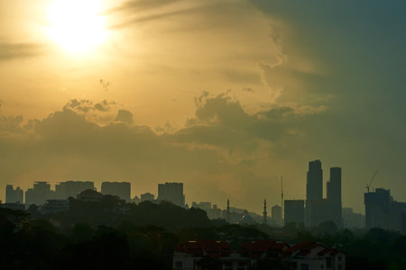 sunset over cloudy foggy modern city.の写真素材