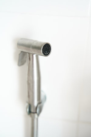 hygiene concept. New hygienic stall shower head on the white wall background. Intimate hygの写真素材