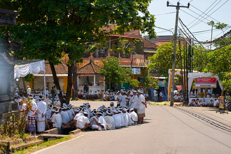 People in traditional festive colorful outfits on the streets of Bali. Bali, Indonesia - 10/12/2022のeditorial素材