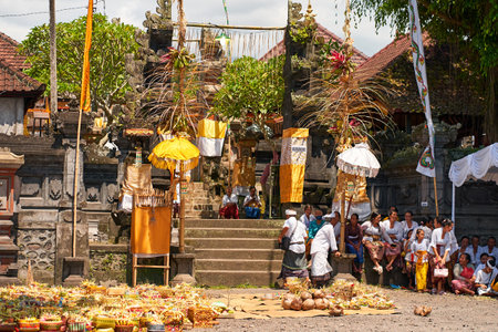 People in traditional festive colorful outfits on the streets of Bali. Bali, Indonesia - 10/12/2022のeditorial素材