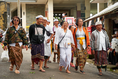People in traditional festive colorful outfits on the streets of Bali. Bali, Indonesia - 12.24.2022のeditorial素材