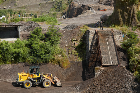 A truck is loaded with volcanic stones at a quarry in Indonesia. Bali, Indonesia - 08/03/2018のeditorial素材