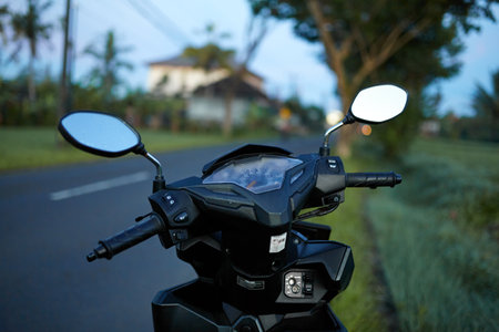 The foggy mirror and the speedometer on the scooter are covered with morning dewの写真素材