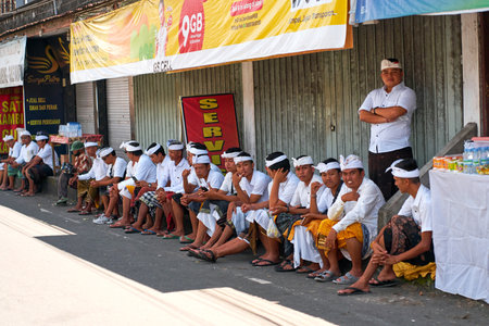 People in traditional festive colorful outfits on the streets of Bali. Bali, Indonesia - 10/12/2022のeditorial素材