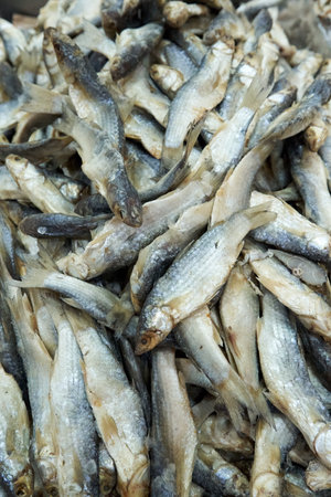 A large assortment of dried fish is on display in the Asian storeの写真素材