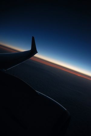 Sunrise and wing, morning aboard an aircraftの写真素材