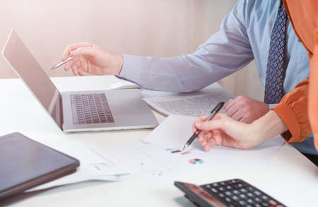 Business people discuss details on a laptop. High quality photo