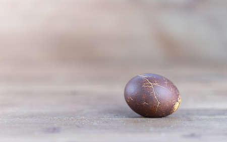 One painted egg is lying on the table. High quality photoの写真素材