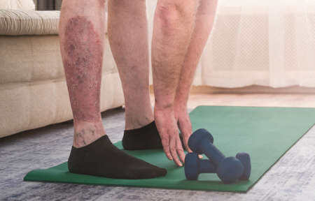 A man does bends at home on the carpet. High quality photo