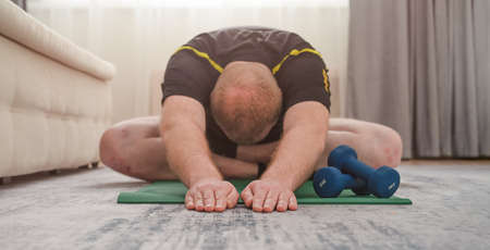 A man does yoga at home. High quality photoの写真素材